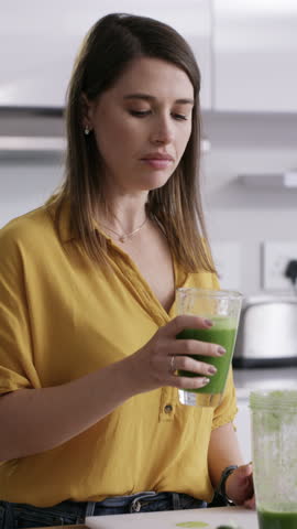 Woman, green juice and diet with smoothie in kitchen for weightloss or detox drink in home. Female person, nutritionist or health with recipe or natural organic ingredients for vitamins in house