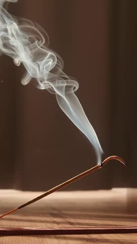 Burning aromatic incense smoky stick for meditation and relaxing. Aromatherapy smoke for yoga or SPA concept. Vertcal