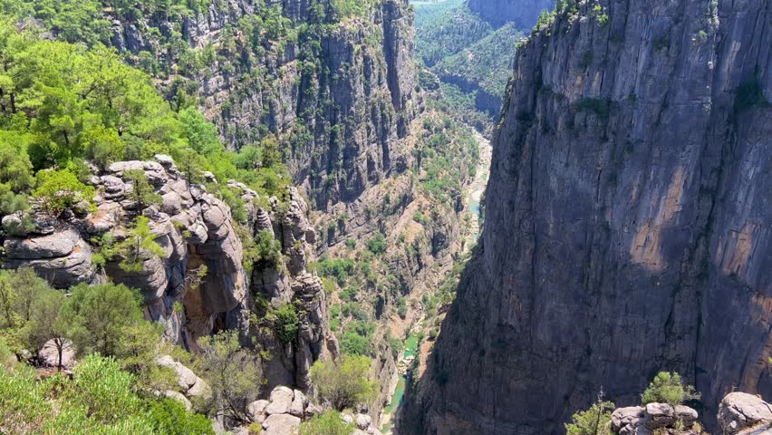 The landscape of a mountain valley with forests and cliffs. Huge rocks and rocky ledges. A beautiful popular canyon, where there are always a lot of tourists. Bird