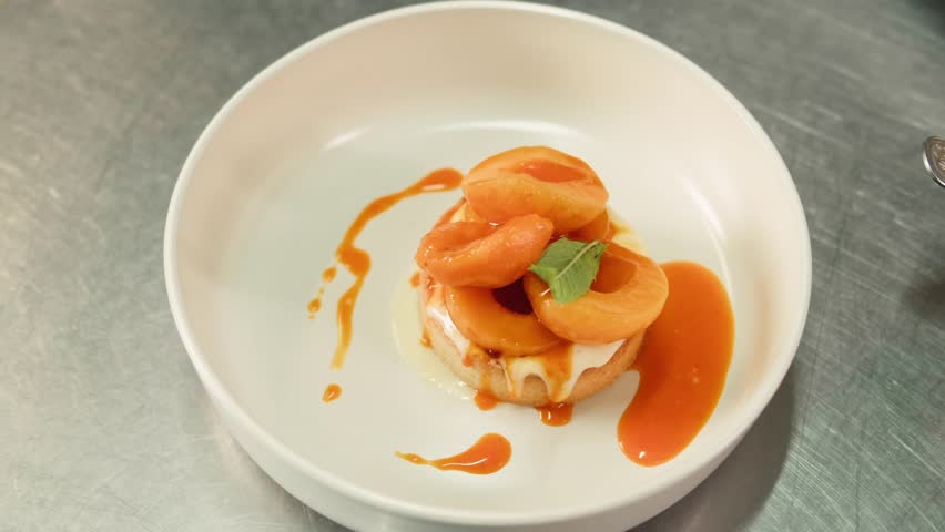 Layered cheesecake with peaches dessert pie in restaurant on white wooden background. top view