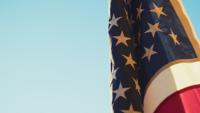 American Flag Standing Against a Sky Background on Veterans Day