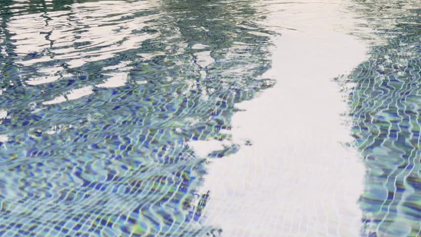 Swimming pool with blue crystal clear water surface and ripple wave background