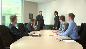Employee awarded in front of workmates. Perfect shot as B-roll on a piece of business and rewards. BONUS - the end of the clip offers another medium shot of workmates applauding.