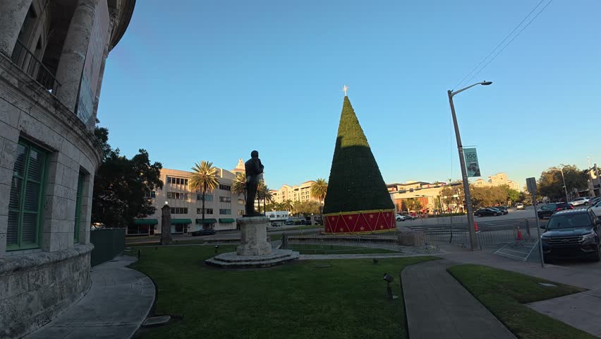 A tall decorated Christmas tree stands during the holiday season.

