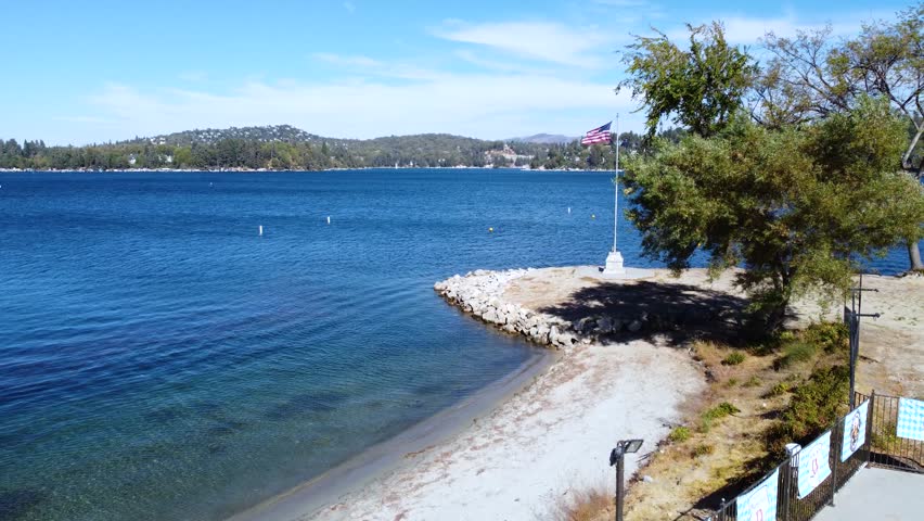 Summer in Lake Arrowhead, California, USA showing lush green forest, mountain lake, and the village town with shops in the San Bernardino Mountains along the route to Big Bear.