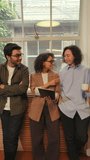 Diverse business people stand by a large window in a modern office, talking openly and sharing ideas while building trust, collaboration, and strong professional connections. - Powered by Shutterstock - Get 15% off with code: PIKWIZARD15