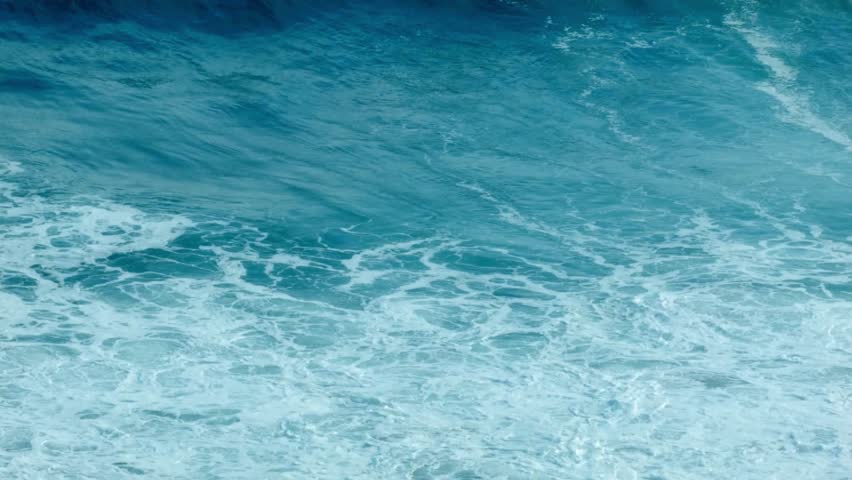 A massive ocean wave cresting and breaking into white sea foam