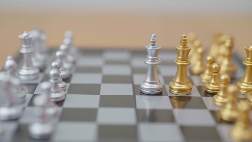hand moving gold Chess King figure and Checkmate opponent during chessboard competition. Strategy, Success, management, business planning, win, disruption, Trade war and leadership concept