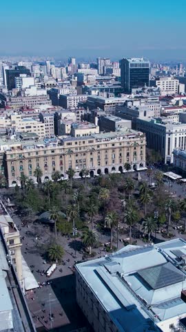 Downtown of Santiago Chile in Metropolitan Region. Panning wide landscape of tourism landmark of capital city of Chile. City life scenery with buildings and traffic at avenue near Andes Mountains.
