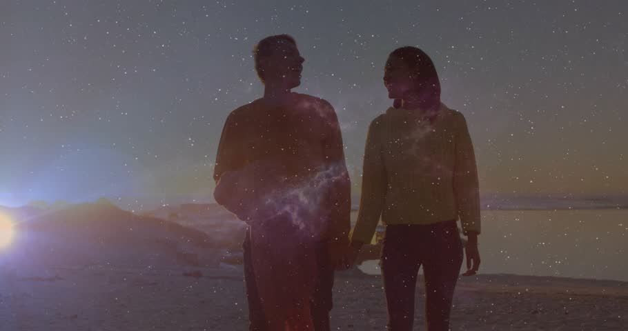 couple entering sunset beach frame walking swinging ball, galaxy overlay brightening for education. Romantic, adventure, exploration, serenity, cosmic, tranquility, scenic