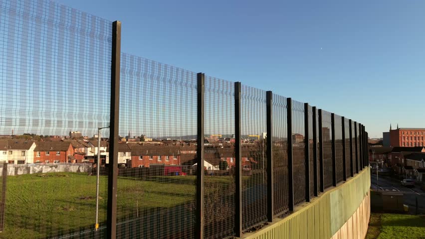 Reversing 4K 60FPS aerial video of the Belfast Peace Wall Interface structure in Belfast, Northern Ireland. The murals explore the politics of NI and worldwide. Produced with Rec709 color.