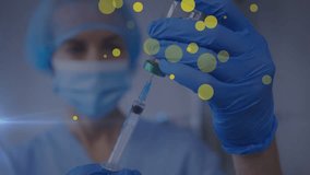 Yellow spots floating against caucasian female health worker wearing a face mask filling a syringe. medical healthcare concept - Powered by Shutterstock - Get 15% off with code: PIKWIZARD15