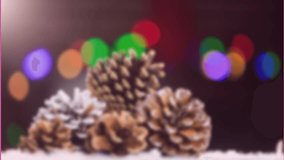 A pine cone decoration on fake snow during christmas time. A retro christmas label is on a green screen. - Powered by Shutterstock - Get 15% off with code: PIKWIZARD15