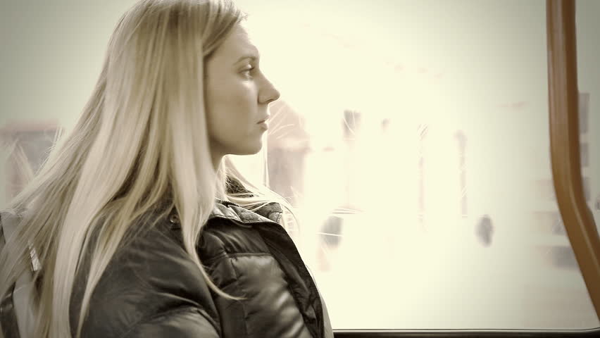 The young beautiful woman sitting in tram