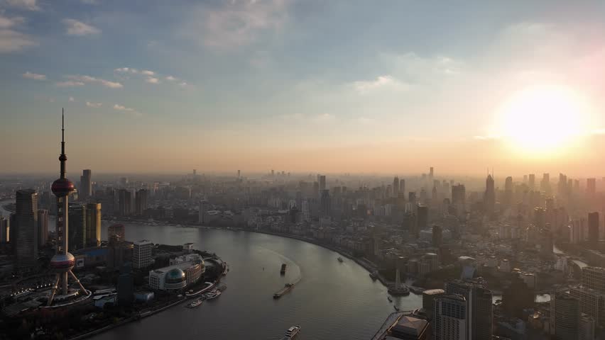Shanghai, China: Aerial panoramic footage of a dramatic sunset over Shanghai skyline with the Hangpu river and the Pudong financial district in China. 