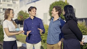 Young business professionals engage in an enthusiastic outdoor meeting, sharing ideas and collaborating on a project. - Powered by Shutterstock - Get 15% off with code: PIKWIZARD15
