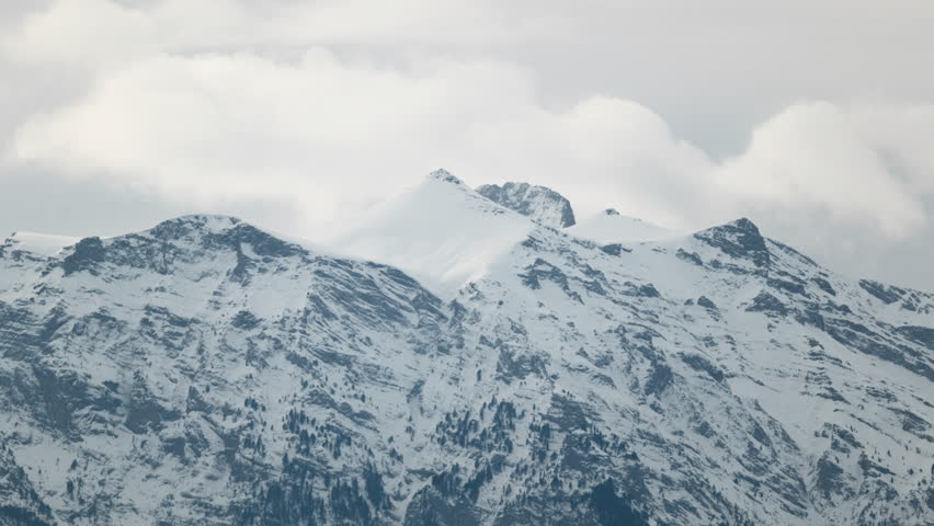 Cinematic winter timelapse of Mount Olympus showing snow covered Mytikas, Stefani and Profitis Ilias peaks with dramatic fast moving clouds above Greece’s tallest mountain.