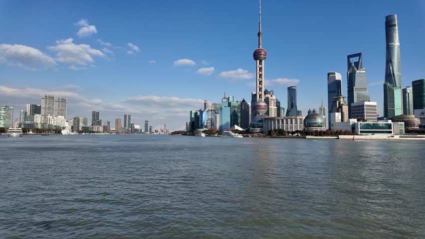 Shanghai, China: Panoramic footage of a the Shanghai city skyline with the modern skyscrapers of Pudong business district from the Bund on the other side of the Hangpu river in China. 