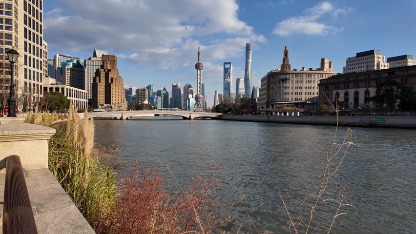 Shanghai, China: Panoramic footage of a the Shanghai city skyline along the Suzhou creek river with ancient colonial buildings and the modern skyscrapers of Pudong financial district in China. 
