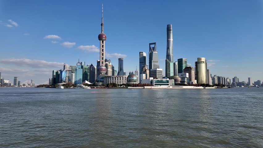 Shanghai, China: Panoramic footage of a the Shanghai city skyline with the modern skyscrapers of Pudong business district from the Bund on the other side of the Hangpu river in China. 