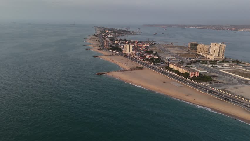 aerial perspective of the Ilha do Cabo land spit in Luanda, Angola, featuring the sandy beach on one side and the calm city bay on the other