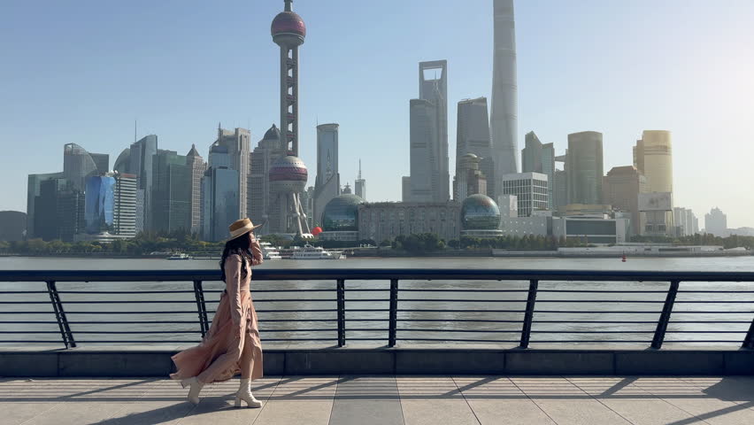 Tourists sightseeing on The Bund and Lujiazui of Shanghai, China.