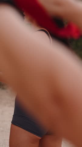 Fit women playing outdoor volleyball in a park