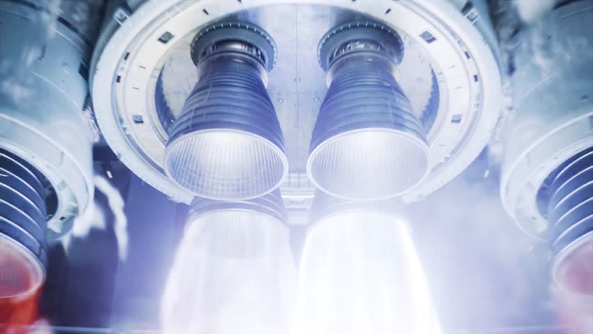 This 4K video captures the intense ignition of multiple rocket engine nozzles during a launch. The visual documents the generation of bright flames, heat, and dense smoke as the propulsion system creates thrust. The composition highlights the mechanical structure of the launch vehicle against the thermal discharge, capturing the powerful energy required for space exploration in high resolution.