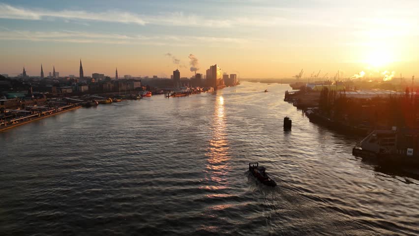 Aerial drone footage of beautiful sunrise over the Elbe River and harbor in Hamburg 