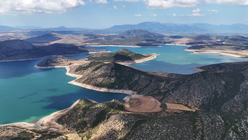 Aerial drone timelapse video of artificial lake of Yliki in Boeotia prefecture with calm waters and beautiful clouds, an important source of drinking water for the Athens, Greece