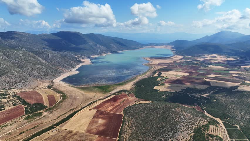 Aerial drone cinematic video of artificial lake of Yliki in Boeotia prefecture with calm waters and beautiful clouds, an important source of drinking water for the Athens, Greece