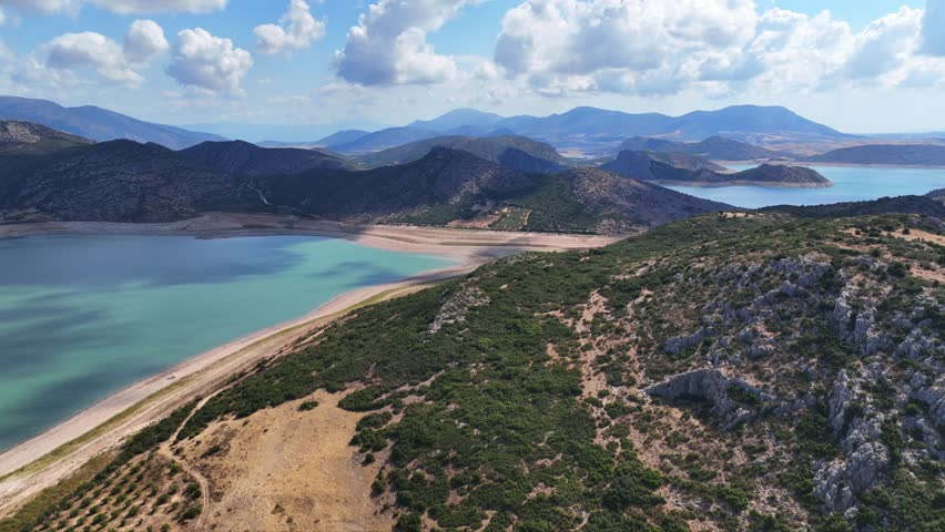 Aerial drone timelapse video of artificial lake of Yliki in Boeotia prefecture with calm waters and beautiful clouds, an important source of drinking water for the Athens, Greece