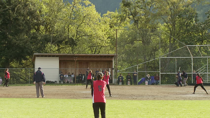 batter hits to third base in girls softball game