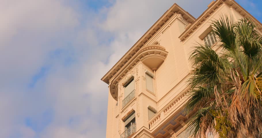Discover the unique architecture of Riviera Palace in Menton, France. The camera captures stunning details and vibrant surroundings, highlighting the historical features under bright skies.