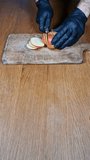 Commercial video of gloved hands slicing a red apple on a cutting board, showing only the hands and knife with black latex gloves against a neutral background.
 - Powered by Shutterstock - Get 15% off with code: PIKWIZARD15