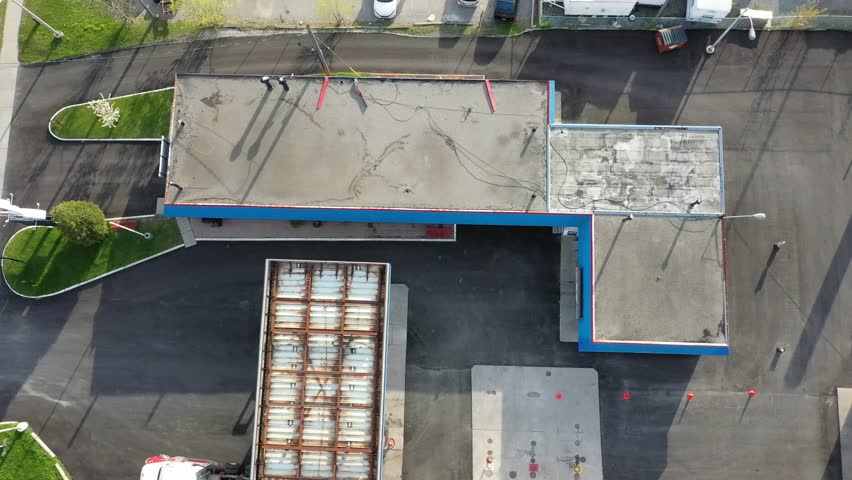 Top down aerial perspective showing an industrial park with various commercial buildings, parking lots, and stored recreational vehicles. In ajax ontario canada