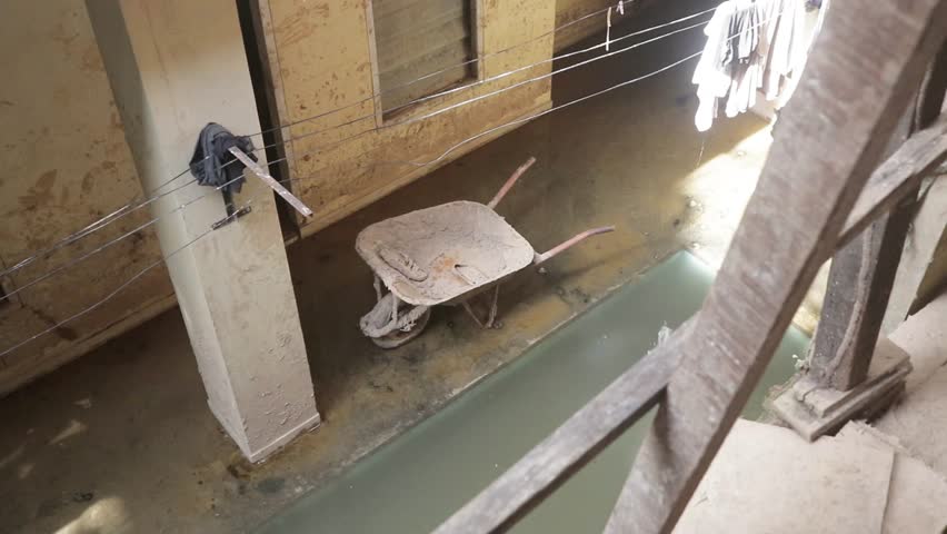 A construction cart parked after debris cleanup following a flash flood disaster. The scene reflects post-disaster recovery efforts and the impact of extreme weather on local communities.