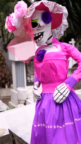 Cemetery scene with paper La Catrina skeletons, vertical frame
