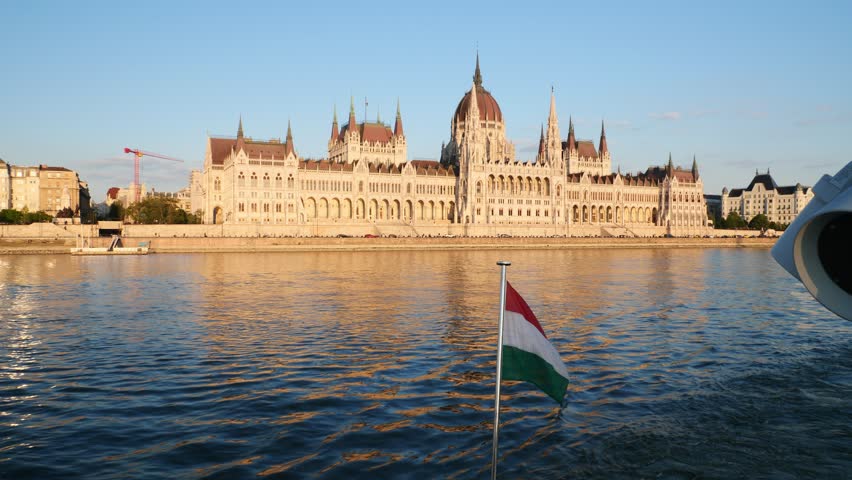 Hungarian flag in a cruise boat with the Parliament house in the background, Budapest, Hungary