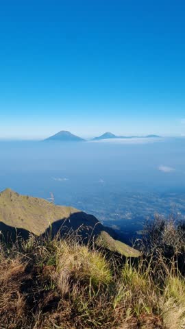 vibes on the top of merbabu mountain java indonesia, view merapi mountain and sea ​​of ​​clouds