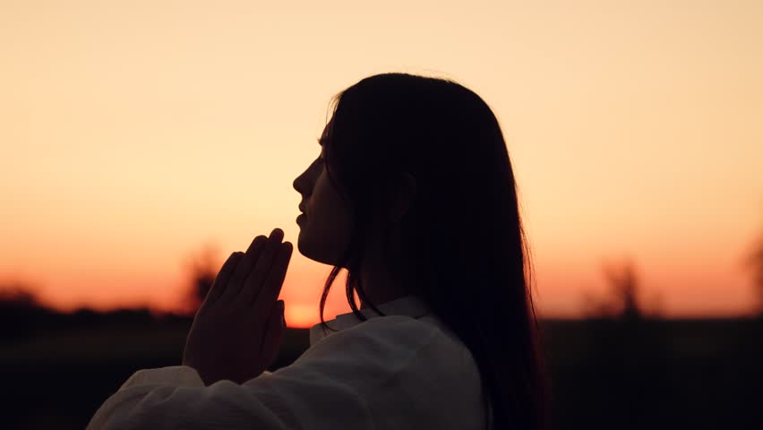 Silhouette woman girl praying, man believing God, woman girl asking forgiveness sunset, looking up sky, praying, giving thanks, asking help, heaven focused gaze, praying outdoors evening, bright