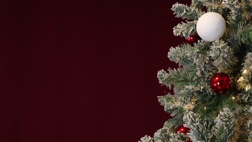 Christmas tree with white and dark red ornaments and red background, establisher