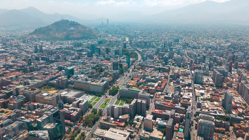 Wide aerial Hyperlapse of Santiago de Chile city traffic, Santa Lucia Hill and skyline, urban landscape