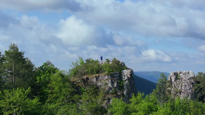 Aerial view of hiker standing on Chimney Top overlook in Monongahela National Forest
