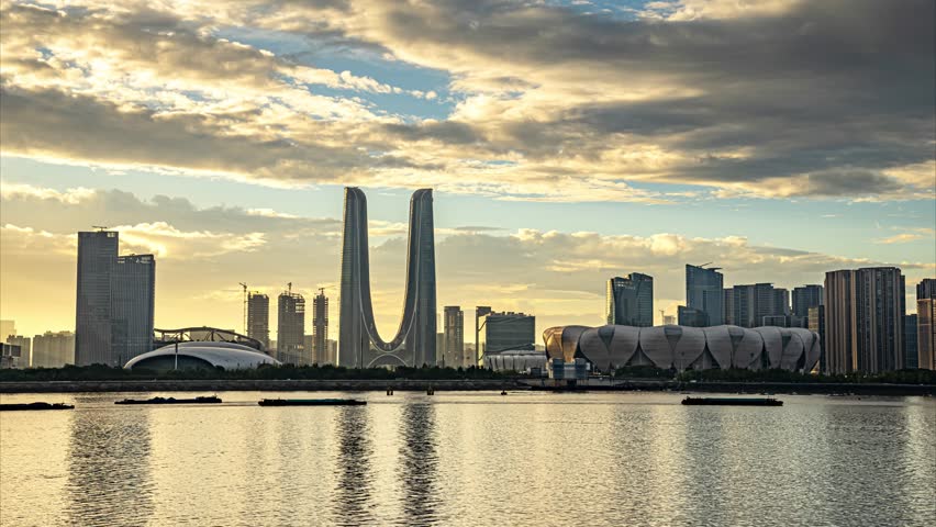 This cinematic aerial time-lapse captures the dynamic essence of Hangzhou, a city where timeless tradition meets cutting-edge modernity. The video journey glides from the serene, reflective waters of the historic West Lake and its iconic pagodas, seamlessly transitioning to the glowing towers of the central business district. As the sun sets, the city awakens into a vibrant nightscape, where rivers of traffic light up arterial roads and grand bridges are illuminated against the dark sky, embodying the city