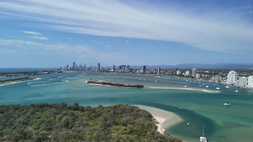 High panoramic view looking over the popular Wave Break Island towards towering skylines of the Gold Coast City, Queensland Australia