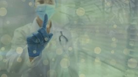 Animation of yellow dots over caucasian female doctor in face mask. Medicine, health and pandemic concept digitally generated video. - Powered by Shutterstock - Get 15% off with code: PIKWIZARD15