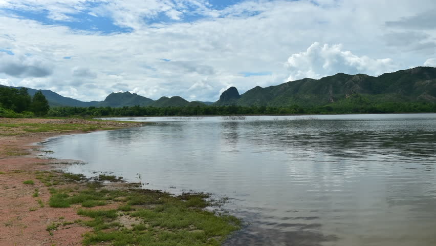 Time Lapse River and Mountain Landscape Under Cloudy Sky