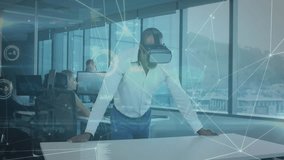 Mature man donning virtual headset exploring data interface with overlays as colleagues monitoring. Technology, innovation, collaboration, futuristic, digital, enterprise, data - Powered by Shutterstock - Get 15% off with code: PIKWIZARD15