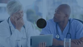 Animation of network of connections over diverse doctors talking and using laptop. Global medicine and digital interface concept digitally generated video. - Powered by Shutterstock - Get 15% off with code: PIKWIZARD15